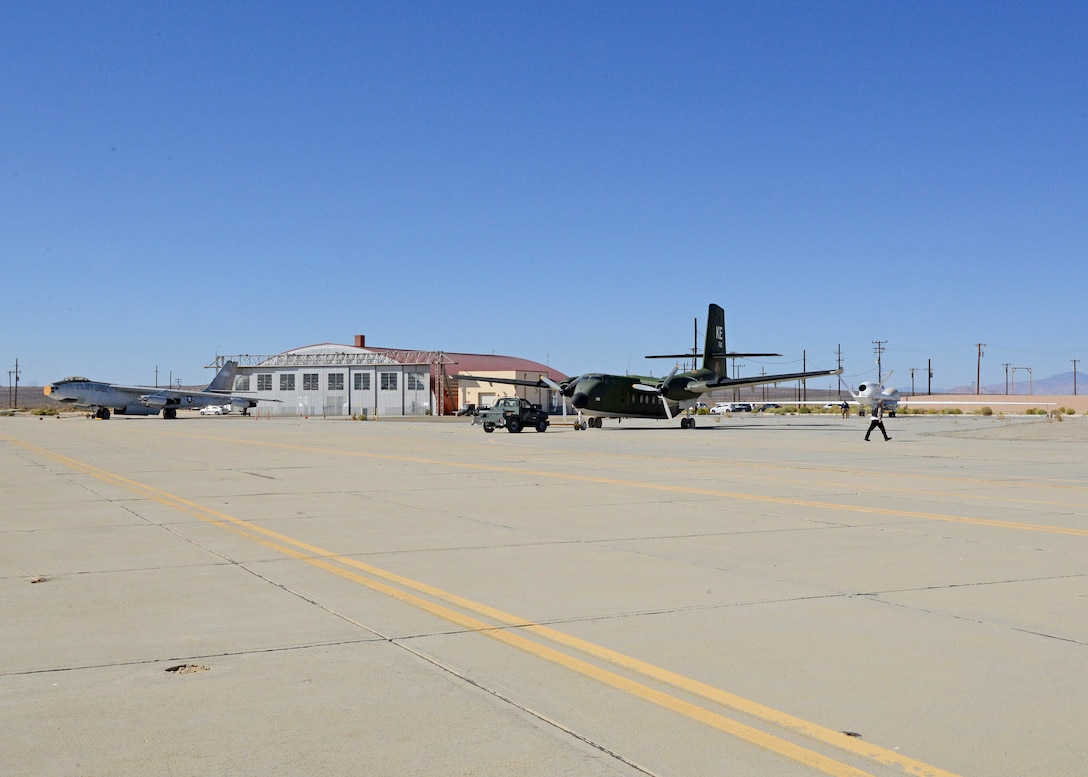 A C-7A Caribou is towed across Rogers Dry Lakebed from Edwards AFB's main base to the Air Force Flight Test Museum restoration hangar Oct. 15. (U.S. Air Force photo by Kenji Thuloweit)