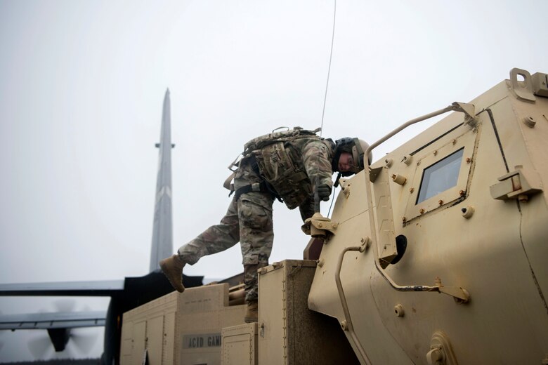 U.S. Army Staff Sgt. Shane Woods, a High Mobility Artillery Rocket System (HIMARS) chief assigned to Alpha Battery, 3rd Battalion, 27th Field Artillery Regiment (HIMARS), 18th Field Artillery Brigade, Fort Bragg, N.C., mounts an antenna on a M142 HIMARS at Fort Greely, Alaska, Oct. 19, 2018, during Red Flag-Alaska 19-1. Wood’s unit was tasked to provide long-range artillery support during RF-A, allowing the unit to showcase its capabilities and develop relationships with other services. The antenna helped maintain FM radio communications with the members of their unit.