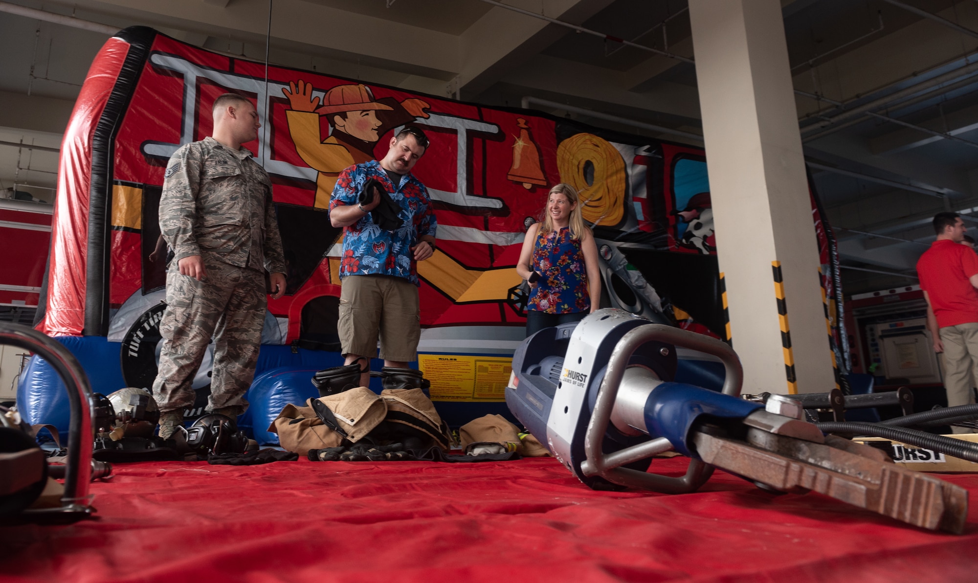 U.S. Air Force Staff Sgt. Benjamin Lalime, 18th Civil Engineer Squadron firefighter, shows participants of the Fire Station 1 Open House rescue equipment Oct. 6, 2018, on Kadena Air Base, Japan. The open house was hosted by the 18th CES to raise awareness about fire safety during Fire Prevention Week. (U.S. Air Force photo by Staff Sgt. Micaiah Anthony)