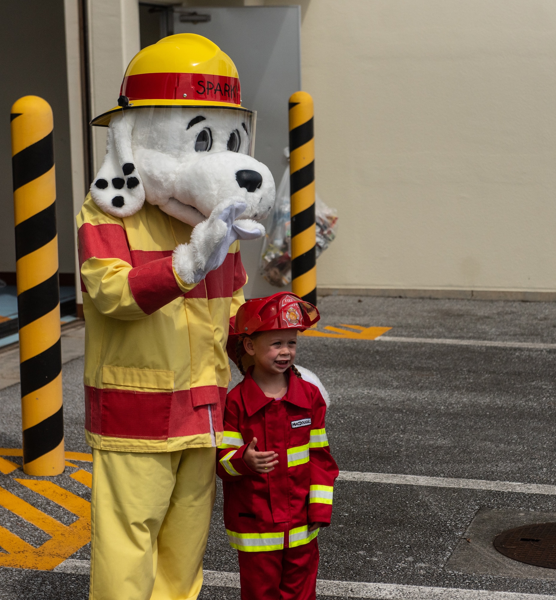 Sparky the Fire Dog takes a photo with a child during the Fire Station 1 Open House Oct. 6, 2018, on Kadena Air Base, Japan. The open house was hosted by the 18th Civil Engineer Squadron to raise awareness about fire safety during Fire Prevention Week. (U.S. Air Force photo by Staff Sgt. Micaiah Anthony)