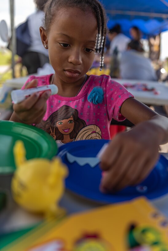 A child makes a mask during the Paws Against Domestic Violence event Oct. 20, 2018, at Kadena Air Base, Japan. U.S. Army, Air Force and Marine Corps family advocacy agencies came together to host the event to raise awareness for domestic violence for the Okinawa military community. (U.S. Air Force photo by Staff Sgt. Micaiah Anthony)