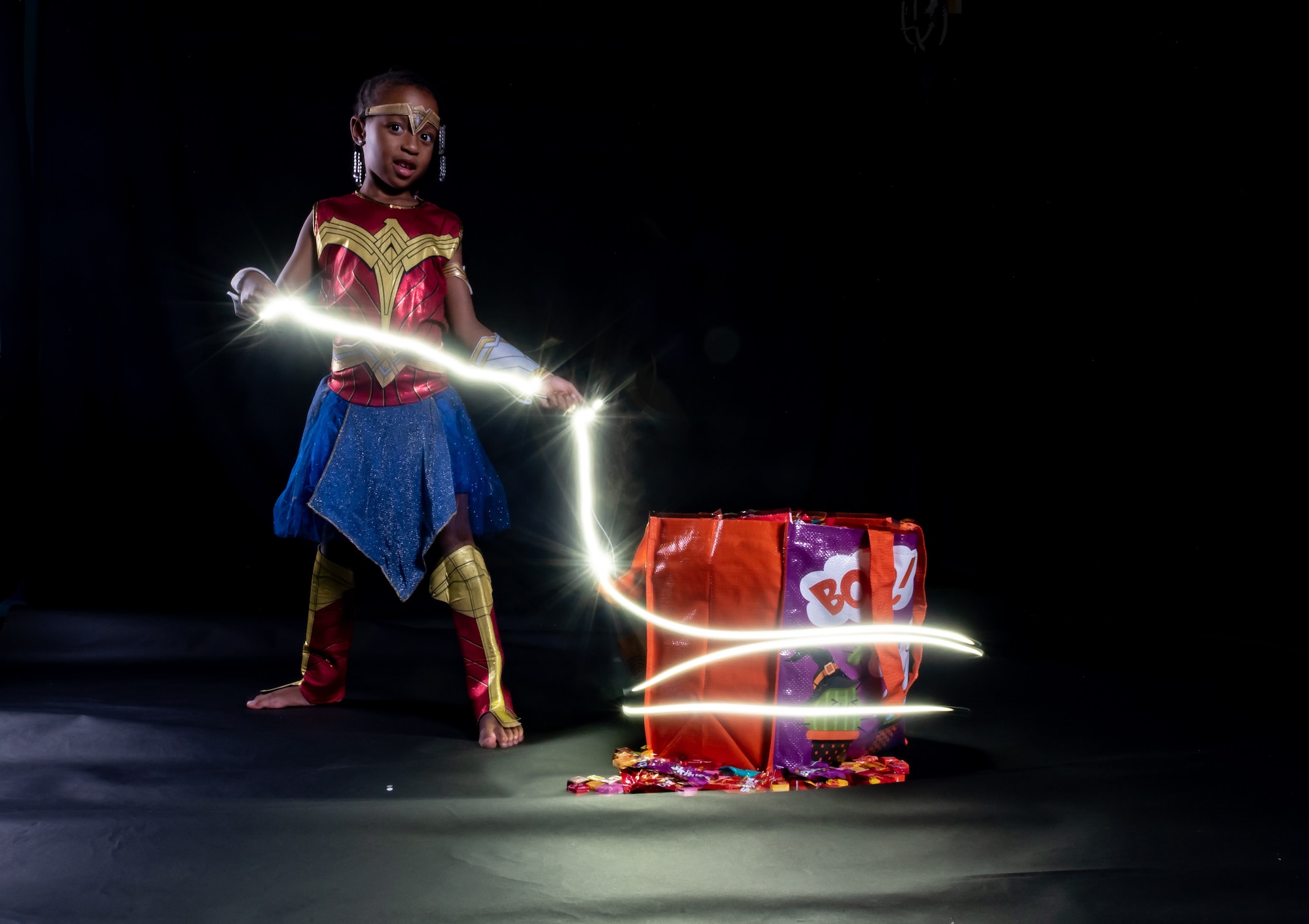A child in a Halloween costume poses for a photo Oct. 24, 2018, at Kadena Air Base, Japan. To ensure a safe and fun Halloween, parents and guardians are encouraged to incorporate lights or reflective materials into costumes or carry glow sticks or flashlights to increase visibility during hours of darkness. (U.S. Air Force photo by Staff Sgt. Micaiah Anthony)