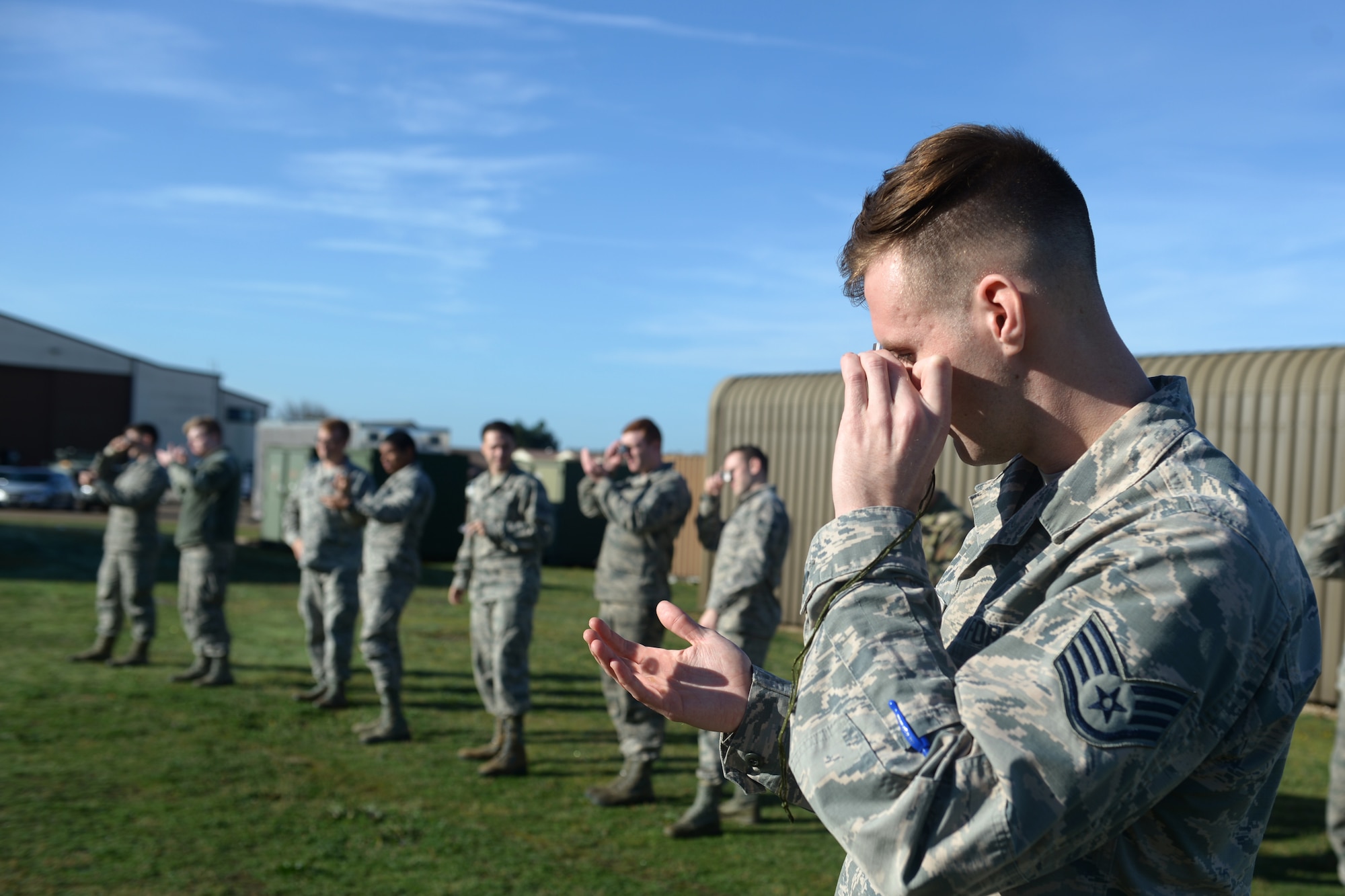 Airmen practice using a mirror to signal help at a Survival, Evasion, Resistance and Escape training program at Royal Air Force Lakenheath, England, Oct. 18, 2018. SERE specialists recommend that personnel get familiar with the basic survival tools provided before they find themselves in a situation that may require them. (U.S. Air Force photo by Airman 1st Class Shanice Williams-Jones)