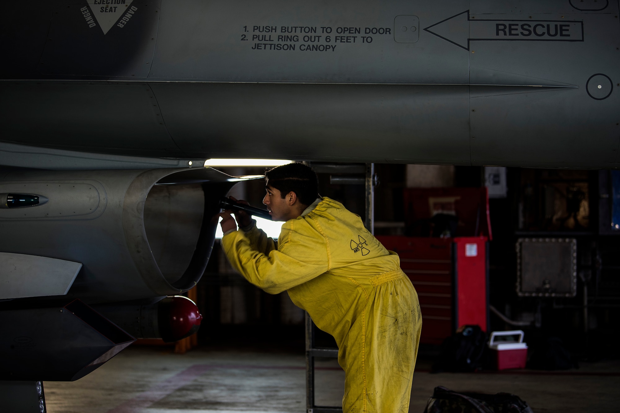 U.S. Air Force Staff Sgt. Martin Perez, 52nd Aircraft Maintenance Squadron tactical aircraft maintainer, inspects an F-16 Fighting Falcon intake at Spangdahlem Air Base, Germany, Sept. 13, 2018. Inspections are conducted after each flight to ensure there are no foreign objects, damage, or fuel leaks in the intake. (U.S. Air Force photo by Airman 1st Class Valerie Seelye)