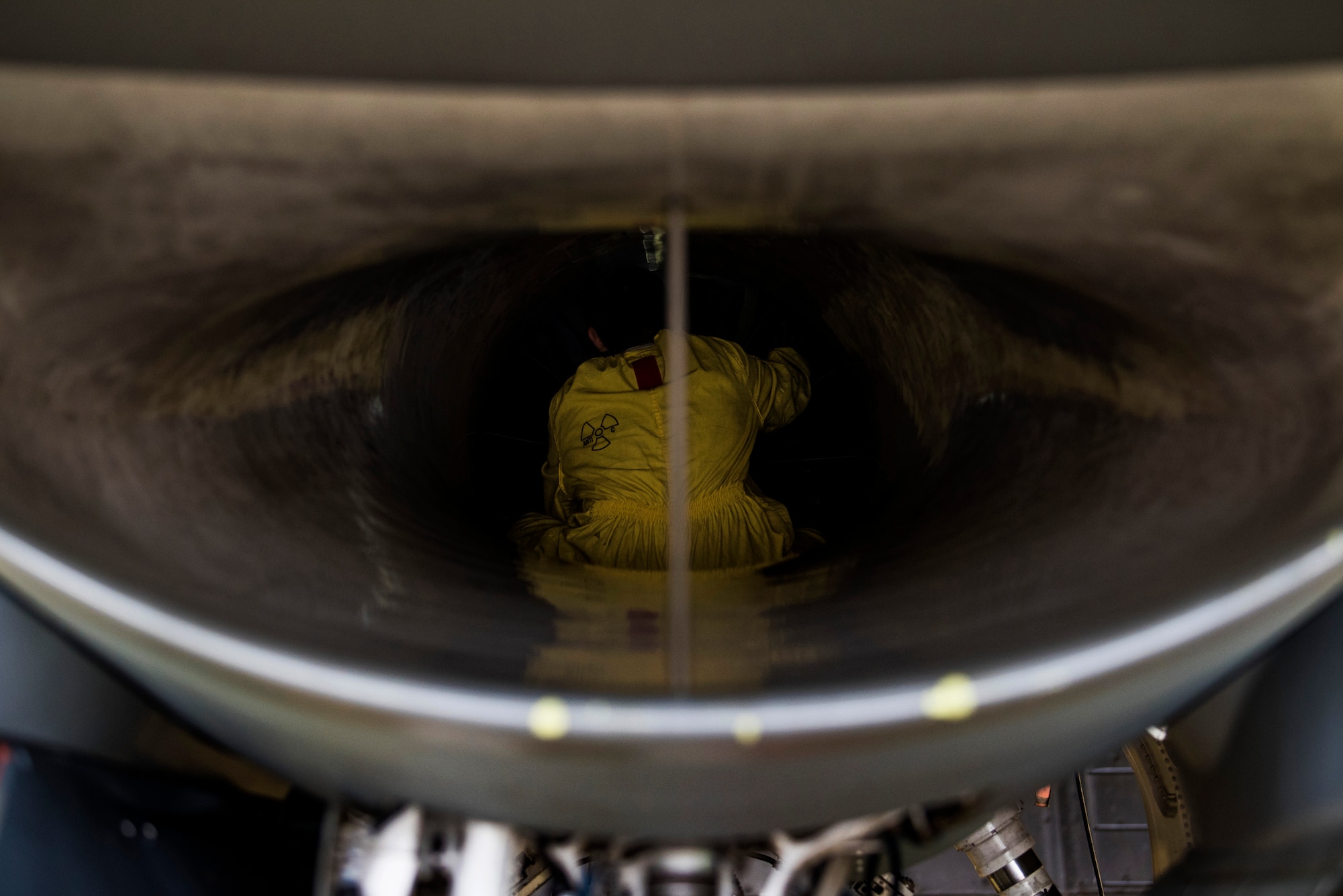 U.S. Air Force Staff Sgt. Martin Perez, 52nd Aircraft Maintenance Squadron tactical aircraft maintainer, inspects an F-16 Fighting Falcon intake at Spangdahlem Air Base, Germany, Sept. 13, 2018. Perez wore a unique suit with no pockets or zippers to eliminate scratching the aircraft. Inspectors carry only a flashlight and a mirror to ensure nothing is left in the intake. (U.S. Air Force photo by Airman 1st Class Valerie Seelye)