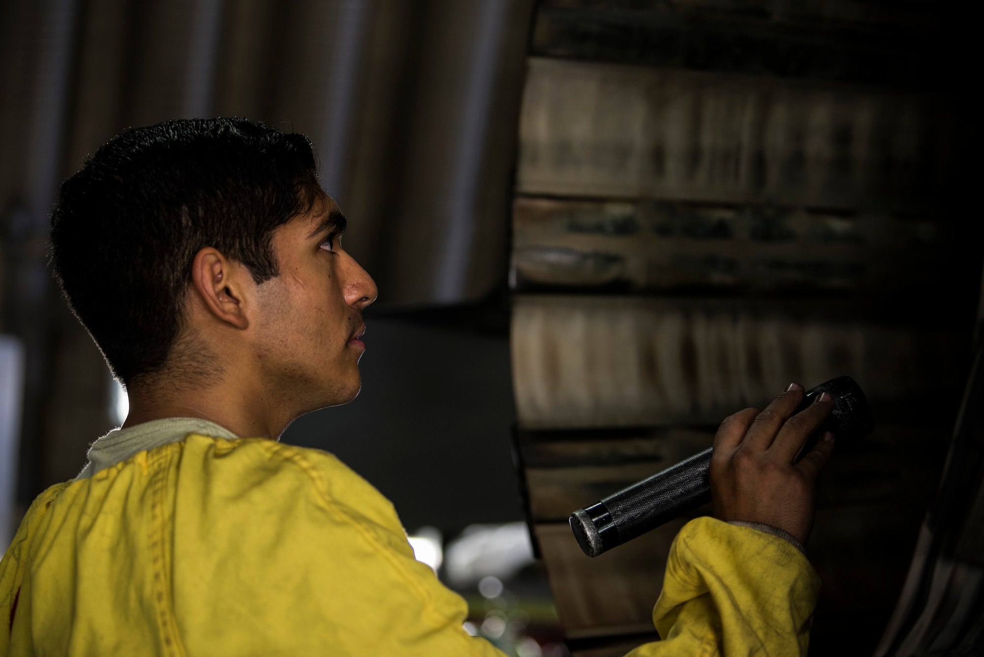 U.S. Air Force Staff Sgt. Martin Perez, 52nd Aircraft Maintenance Squadron tactical aircraft maintainer, inspects an F-16 Fighting Falcon exhaust at Spangdahlem Air Base, Germany, Sept. 13, 2018. Perez is certified to look for debris, foreign objects, damage, or leaks. F-16s are inspected after each flight. (U.S. Air Force photo by Airman 1st Class Valerie Seelye)