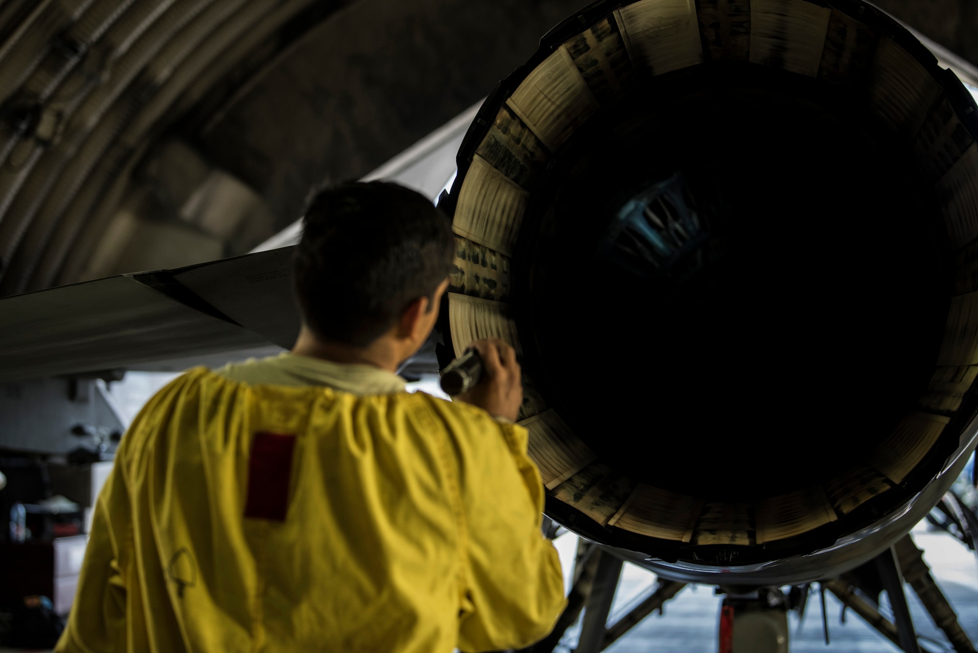 U.S. Air Force Staff Sgt. Martin Perez, 52nd Aircraft Maintenance Squadron tactical aircraft maintainer, inspects an F-16 Fighting Falcon exhaust at Spangdahlem Air Base, Germany, Sept. 13, 2018. The inspection ensured the F-16 had no discrepancies, guaranteeing it was safe to fly. Perez performs aircraft inspections in addition to his regular dedicated crew chief duties. (U.S. Air Force photo by Airman 1st Class Valerie Seelye)
