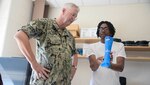 Admiral David Lewis speaks with a technology student at Virginia State University.