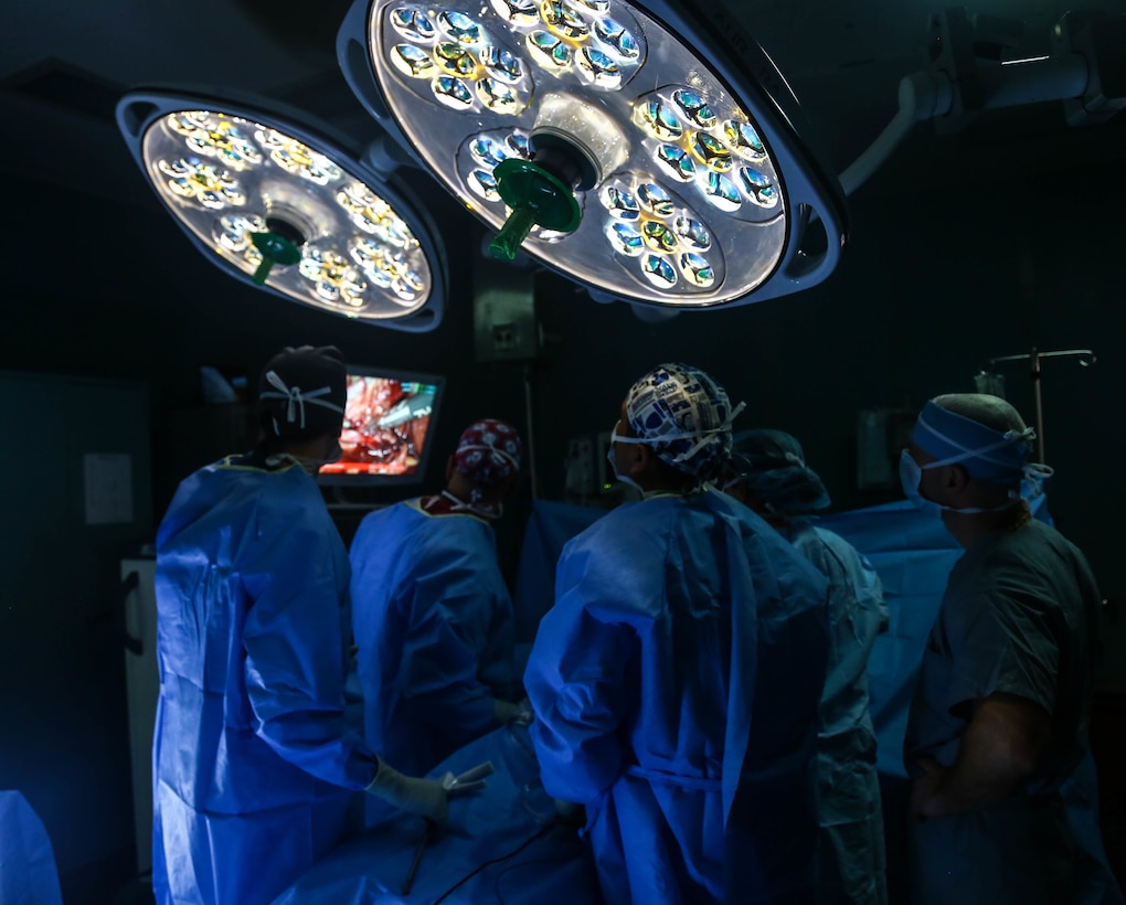 Members of surgical services aboard the hospital ship USNS Comfort (T-AH 20) perform a gallbladder surgery.