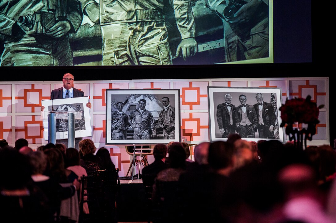 Mark Davis, a radio host from 660 AM The Answer, presented the crowed with two new art pieces created by Maciej Maga at the Frontiers of Flight Museum in Dallas, Oct. 20, 2018.