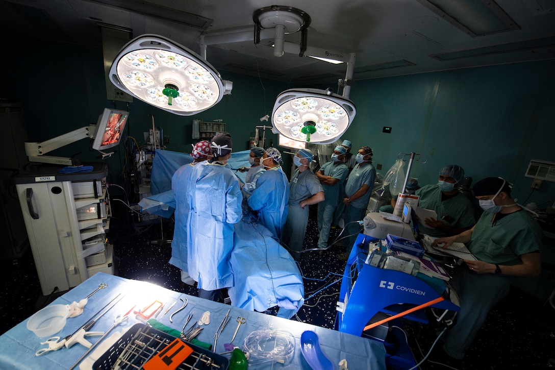 Members of surgical services aboard the hospital ship USNS Comfort (T-AH 20) perform a gallbladder surgery.