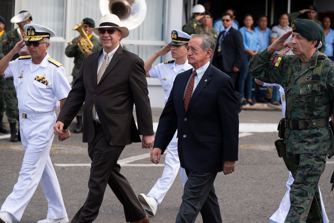 U.S. Ambassador to Ecuador, Todd C. Chapman (center-left) and Ecuadorian Minister of Defense Oswaldo Jarrin (center-right) are escorted during an opening ceremony at one of two medical sites.