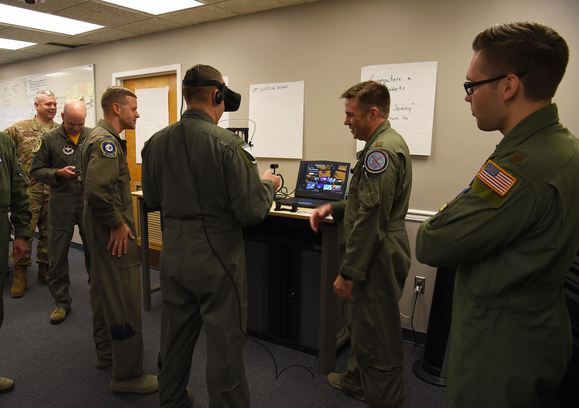 Maj. Ryan Brewer, 14th Flying Training Wing director of innovation, helps Col. Derek Stuart, 14th Operations Group commander, use a virtual reality headset Oct. 19, 2018, on Columbus Air Force Base, Mississippi. Virtual reality headsets, 3D printers, tablets and laptops fill the Spark Cell for Team BLAZE to use while they create and explore their ideas. (U.S. Air Force photo by Airman 1st Class Keith Holcomb)