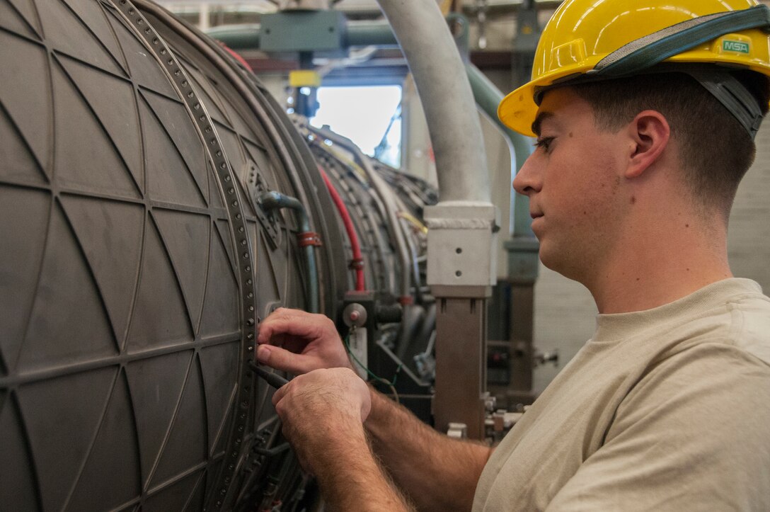 Senior Airman Andrew Feighery, 104th Maintenance Squadron aircraft engine mechanic, removes an augmenter module Oct. 17, 2018, at Barnes Air National Guard Base, Massachusetts. Feighery's recent deployment experience and mechanical engineering studies at The University of Massachusetts have further developed his skills as a mechanic. (U.S. Air National Guard Photo by Airman 1st Class Randy Burlingame)