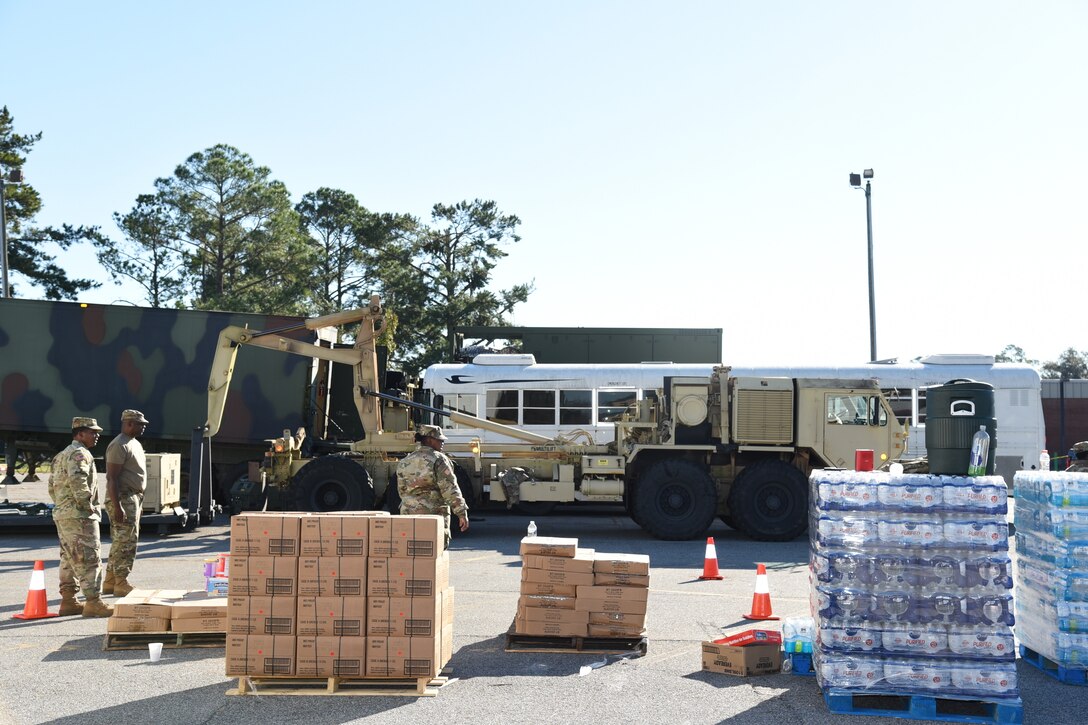 U.S. Airmen and Soldiers from the Georgia National Guard distribute food and water in Miller County, Ga., Oct. 13, 2018 during Hurricane Michael relief efforts. The Georgia National Guard is working in coordination with the Georgia Emergency Management Agency and local authorities to distribute supplies and conduct route clearance. (U.S. Air National Guard photo by Tech. Sgt. Amber Williams)