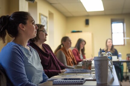 Aspiring Key Spouses listen to a brief on violence prevention at Joint Base Elmendorf-Richardson, Alaska, Oct. 16, 2018. Ten Key Spouses were awarded key-shaped pins following the initial training, bringing the Key Spouse total here to 100. Key Spouses are selected by unit commanders to provide support for their squadron's families.