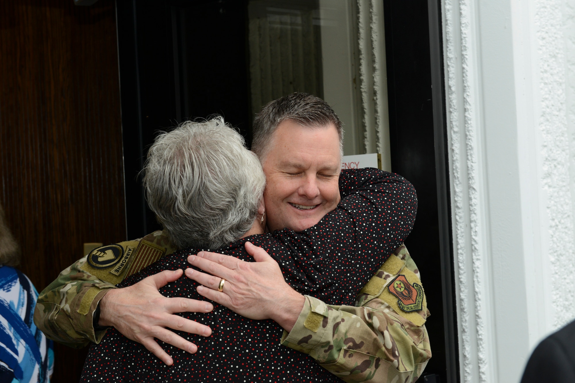 Two people hugging one another.