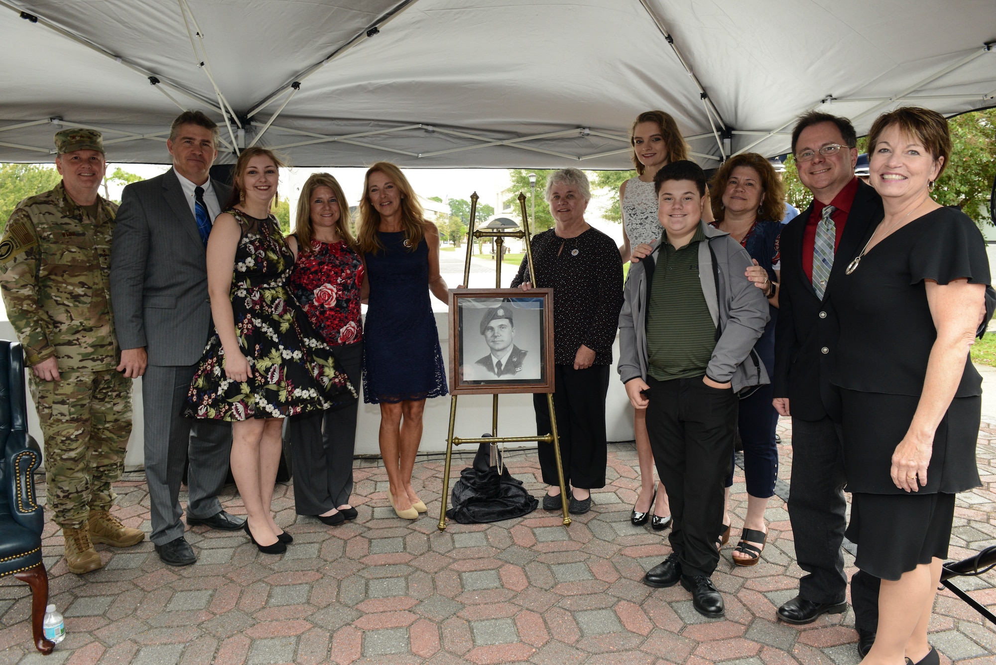 A family standing in front of a portrait