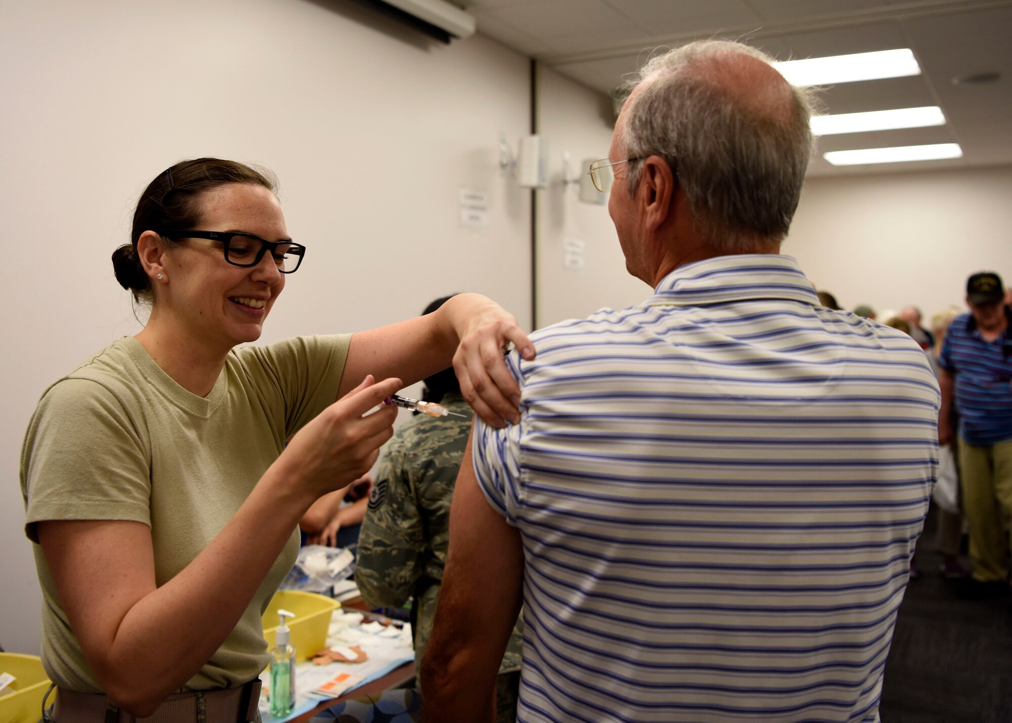 An Airman assigned to the 56th Medical Group administers a shot to a veteran during Retiree Appreciation Day event Oct. 20, 2018, at Luke Air Force Base, Ariz.
