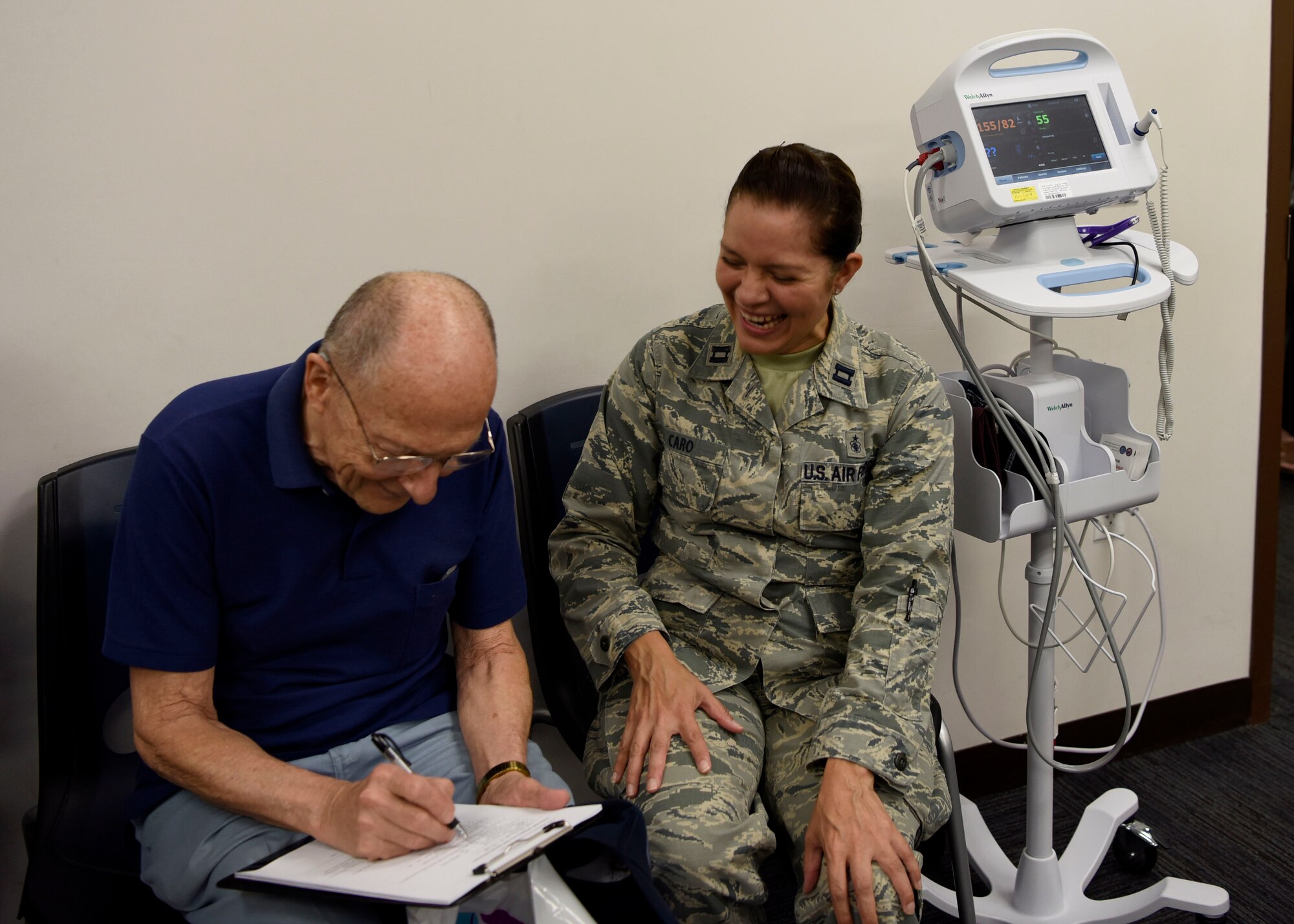 Capt. Ivette Caro, 56th Medical Group family health registered nurse, helps a veteran attending the Retiree Appreciation Day event fill out paperwork Oct. 20, 2018, at Luke Air Force Base, Ariz.