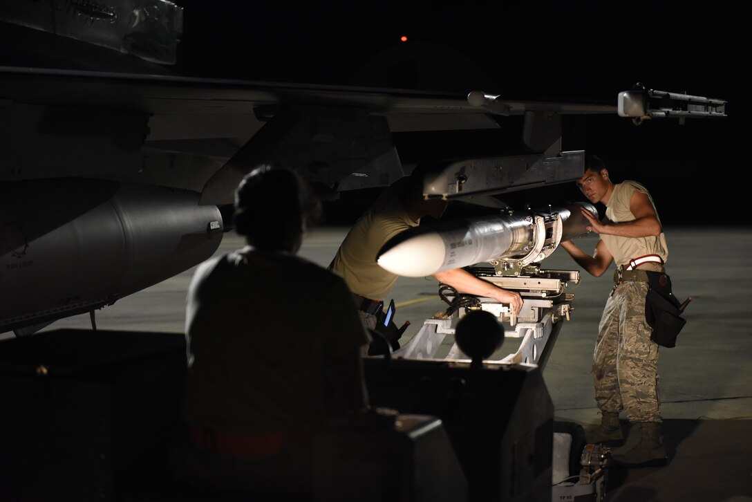 U.S. Air Force Airman 1st Class Ashley Mitchell, Airman 1st Class Sam Echstenkamper, and Staff Sgt. Sam Kimple, weapons loaders assigned to the 180th Fighter Wing, Ohio Air National Guard, load live missiles onto an F-16 Fighting Falcon Sept. 20, 2018 during Combat Archer, a two-week air-to-air Weapons System Evaluation Program to prepare and evaluate operational fighter squadrons' readiness for combat operations, at Tyndall Air Force Base, Florida. Combat Archer enhances the routine training 180FW Airmen receive during the year, ensuring they are qualified and ready to deploy anywhere in the world. (U.S. Air National Guard photo by Staff Sgt. Shane Hughes)