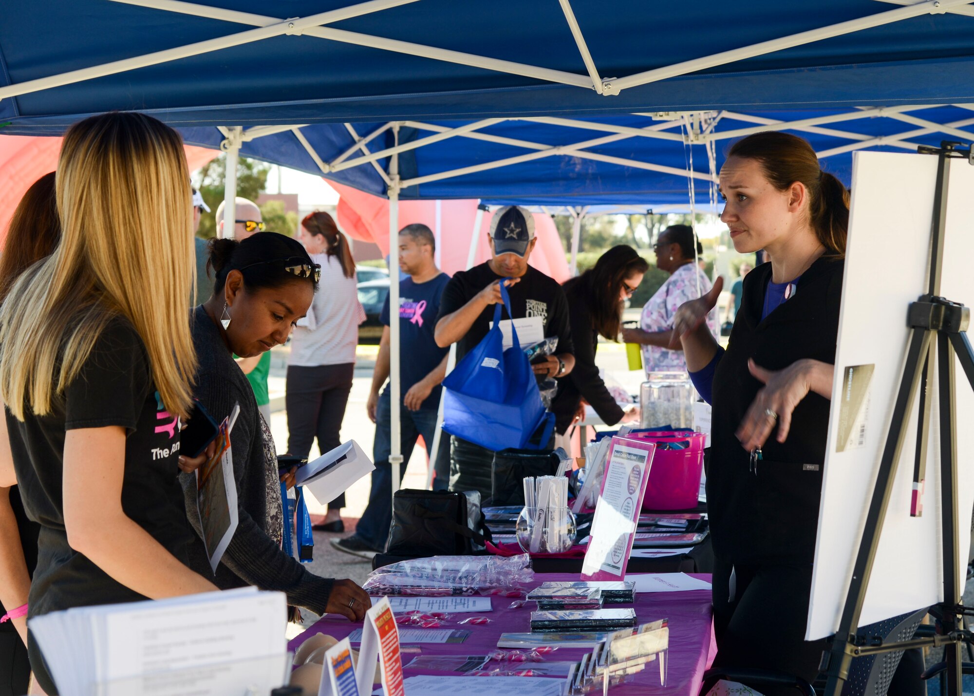Julianne Caberto, a women’s health registered nurse with the 412th Medical Group Clinic, discusses self-breast exams during the Breast Cancer Awareness Health Fair and 5k Run/Walk on Edwards Air Force Base, California, Oct. 23. (U.S. Air Force photo by Giancarlo Casem)