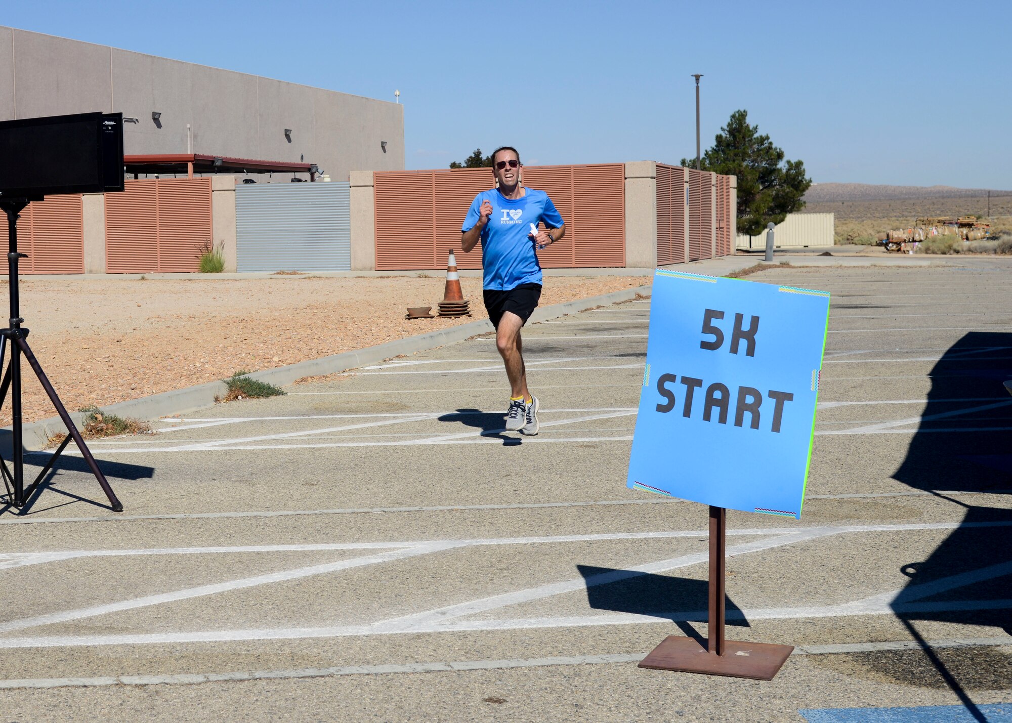 Maj. Charles Chambers, 412th Operations Group, finishes the Breast Cancer Awareness Health Fair and 5k Run/Walk on Edwards Air Force Base, California, Oct. 23. Chambers came in first-place overall. (U.S. Air Force photo by Giancarlo Casem)