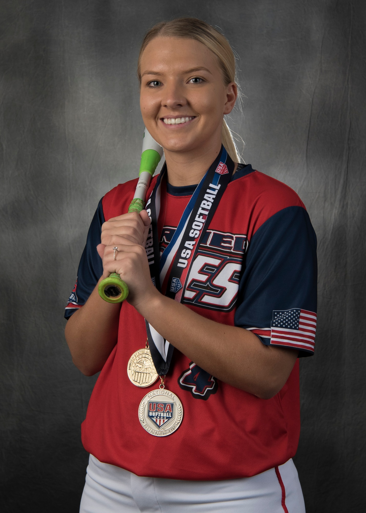 Senior Airman Tori Tilley poses for a personality portrait Oct. 4, in the Public Affairs Studio on Holloman Air Force Base, N.M. Tilley is in her U.S. Armed Forces Softball uniform with the two medals she received competing this year. (U.S. Air Force photo by Airman Autumn Vogt)