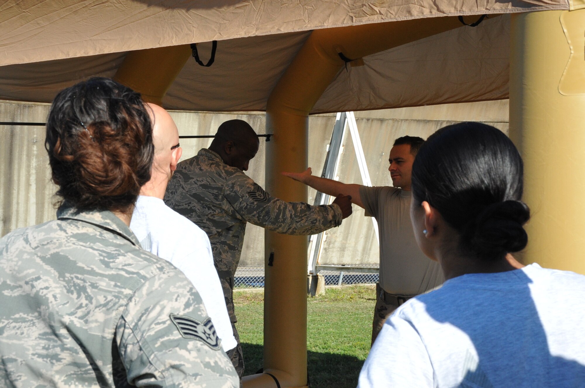 Tech. Sgt. Johnny Woodland II, 403rd Operation Support Squadron aircraft flight equipment technician simulates using a device to check for contamination on an aircrew member during a refresher training on the decontamination procedures of aircrew members at Keesler Air Force Base, Mississippi, during the October unit training assembly.  The AFE, formerly known as life support, are responsible for the safety of the aircrew members, including the decontamination line in the event of a biological, radiological, or chemical attack.  (U.S. Air Force photo by Master Sgt. Jessica Kendziorek)