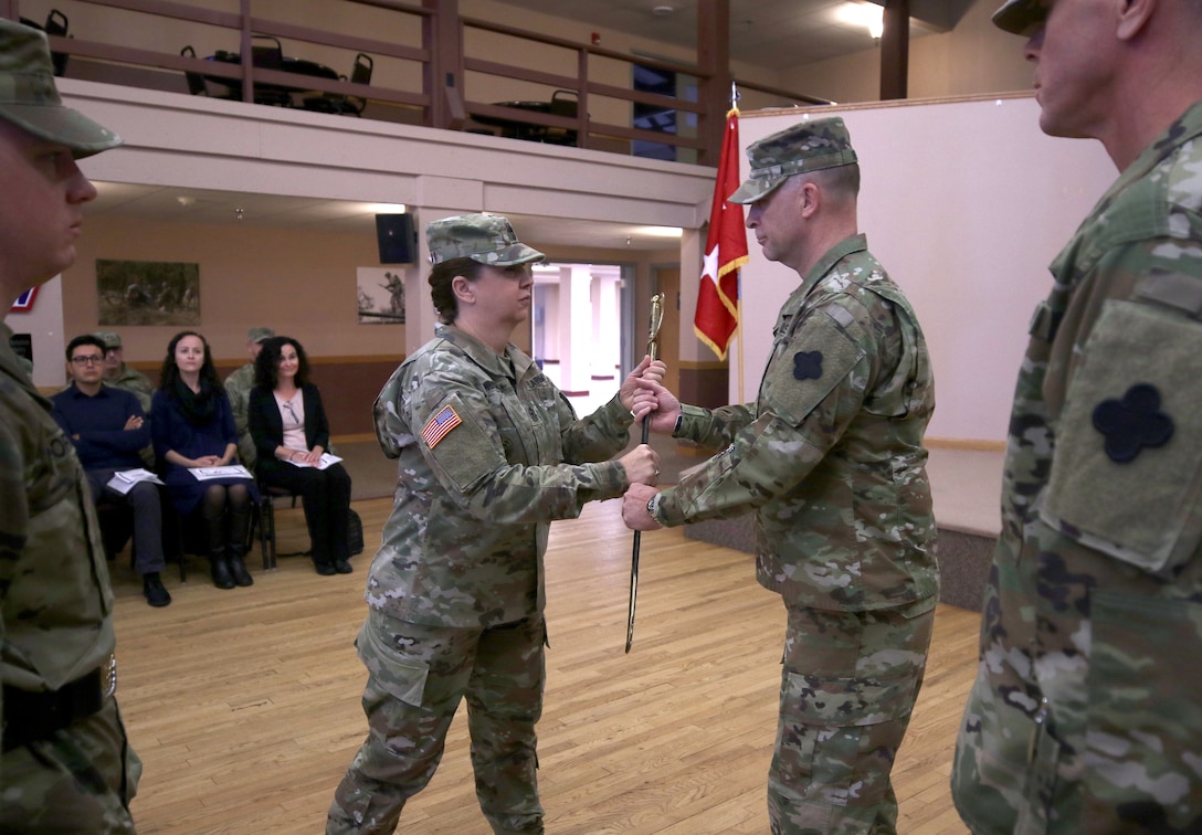 Command Sgt. Maj. Sara E. Noskowiak, U.S. Army Reserve Music Command Sergeant Major, relinquishes her 1840 noncommissioned officer musicians sword to Maj. Gen. Patrick J. Reinert, 88th Readiness Division commanding general, during a change of responsibility ceremony at Fort McCoy, Wisconsin, Oct. 20th, 2018.