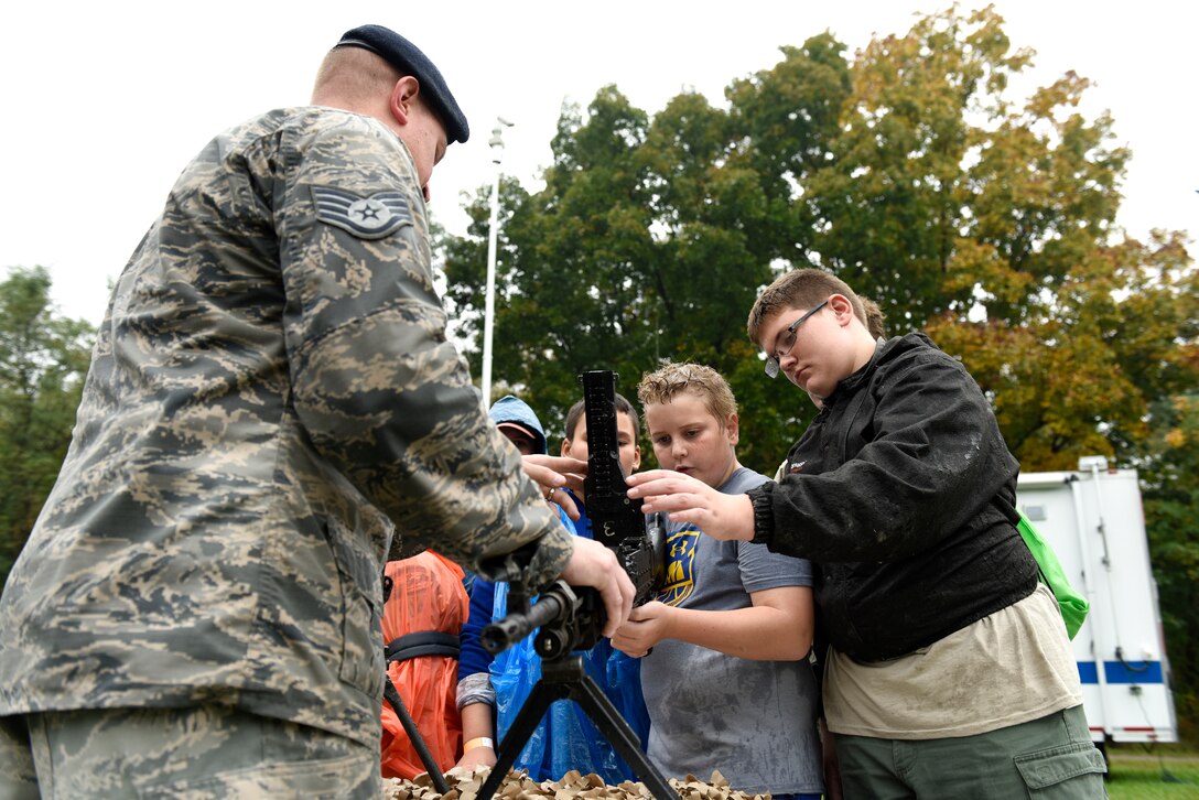 Casey Reed and Uriah Blair, Boy Scouts from Troop 304 out of Findlay, Ohio, learns about the different weapons from Staff Sgt. Kyle York, a security forces specialist assigned to the 180th Fighter Wing, Ohio Air National guard during the Camp Frontier  50th Anniversary camporall Oct. 6, 2018 in Pioneer, Ohio. Airmen from the 180FW participated in the event, helping to build and sustain the relationship with the Northwest Ohio community. (U.S. Air National Guard Photo by Staff Sgt. Shane Hughes)