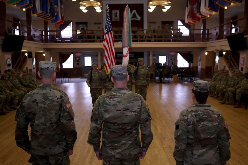 Maj. Gen. Patrick J. Reinert, 88th Readiness Division commanding general, stands on stage between the incoming U.S. Army Reserve Army Music command sergeant major, Master Sgt. Keith M. Barlow, and the outgoing U.S. Army Reserve Army Music command sergeant major, Command Sgt. Maj. Sara E. Noskowiak, during a change of responsibility ceremony at fort McCoy, Wisconsin, Oct. 20, 2018. The COR represents another page in the long history book of U.S. Army music, dating back to 1756 when Col. Benjamin Franklin, marched with more than 1,000 men, accompanied by fife-players and other musicians.