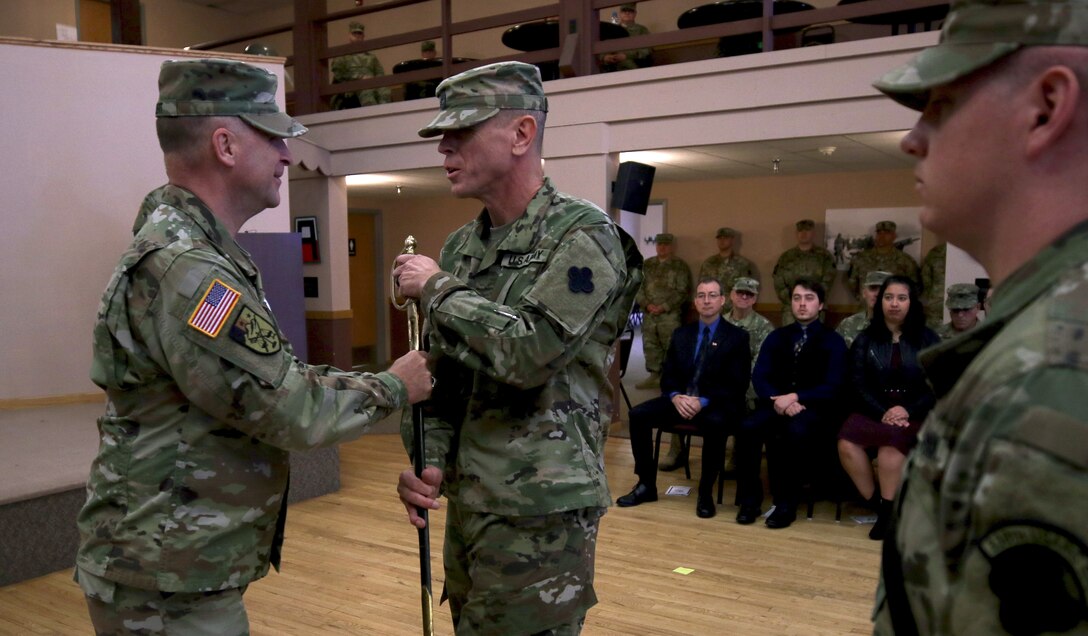 Maj. Gen. Patrick J. Reinert, commanding general of the 88th Readiness Division, hands an 1840 noncommissioned officer musicians sword to Master Sgt. Keith M. Barlow. The sword passing represents relinquishing responsibility from the outgoing senior noncomissioned officer to the incoming noncomissioned officer.