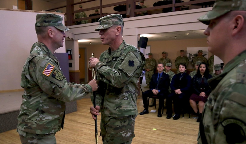 Maj. Gen. Patrick J. Reinert, commanding general of the 88th Readiness Division, hands an 1840 noncommissioned officer musicians sword to Master Sgt. Keith M. Barlow. The sword passing represents relinquishing responsibility from the outgoing senior noncomissioned officer to the incoming noncomissioned officer.