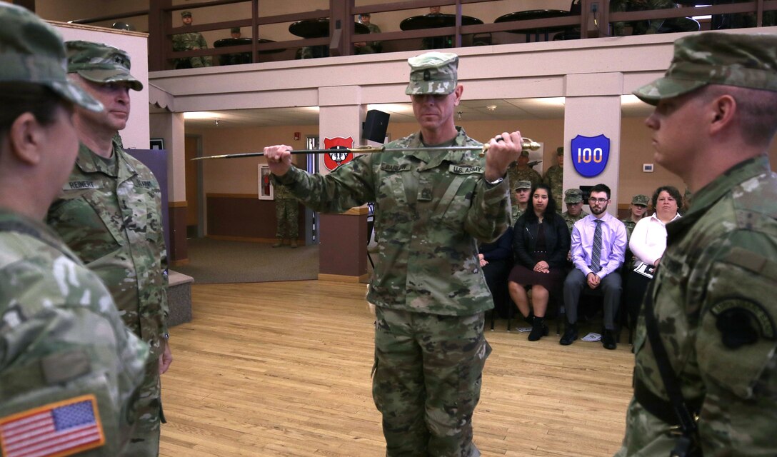 Master Sgt. Keith M. Barlow, U.S. Army Reserve Music sergeant major, 88th Readiness Division, inspects an 1840 U.S. noncomissioned officer musicians sword during a change of responsibility ceremony at Fort McCoy, Wisconsin, Oct. 20, 2018. Barlow takes over the position from Command Sgt. Maj. Sara E. Noskowiak. The sword passing represents relinquishing responsibility from the outgoing senior noncomissioned officer to the incoming noncomissioned officer.