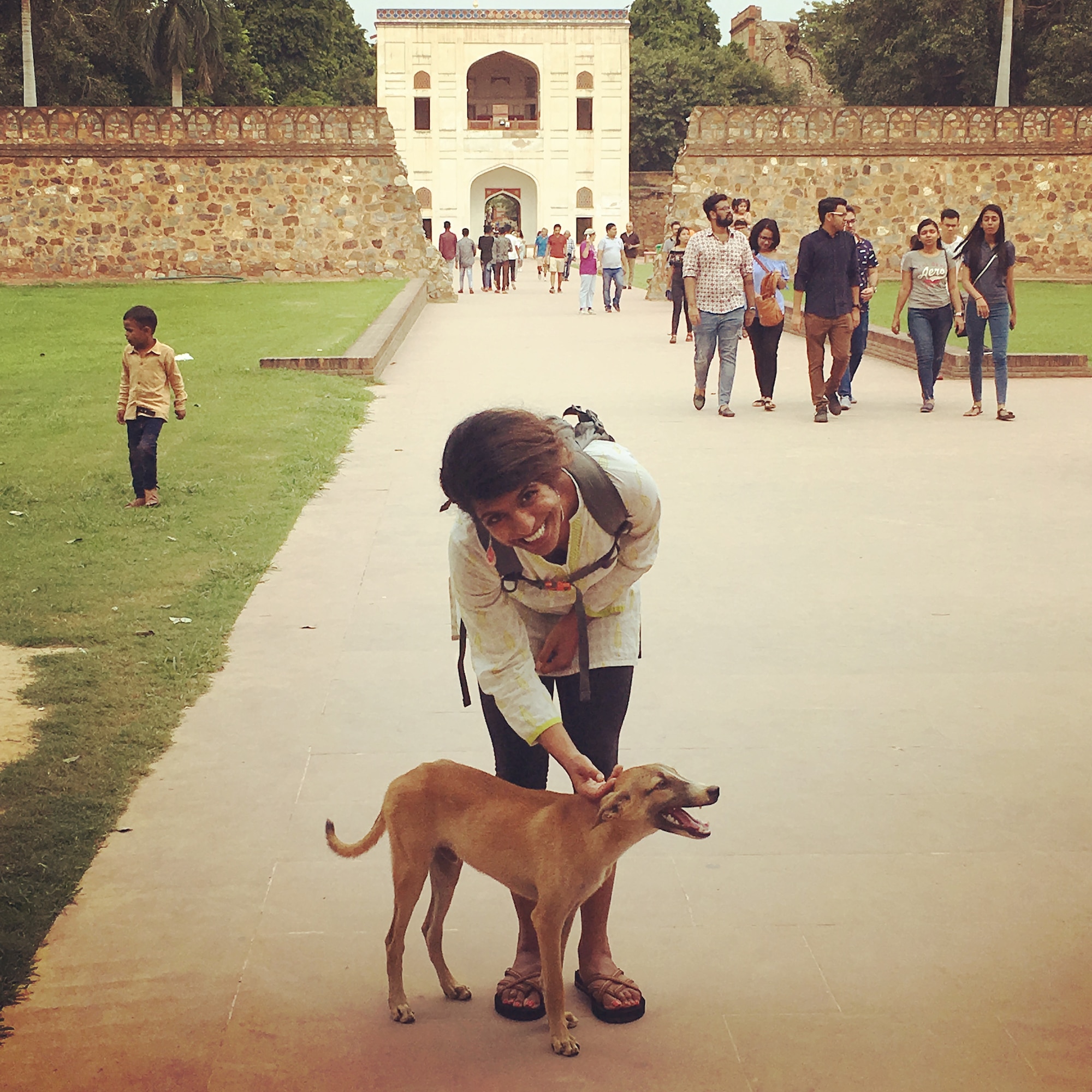 U.S. Air Force Capt. Krystal Lowder, 33rd Fighter Wing Protocol chief of protocol, pets a dog Aug. 25 ,2018, in New Delhi, India. Lowder was accepted into the Air Force's LEAP program. LEAP identifies and cultivates the existing foreign language skills of Airmen for the life of their career. (Courtesy photo)