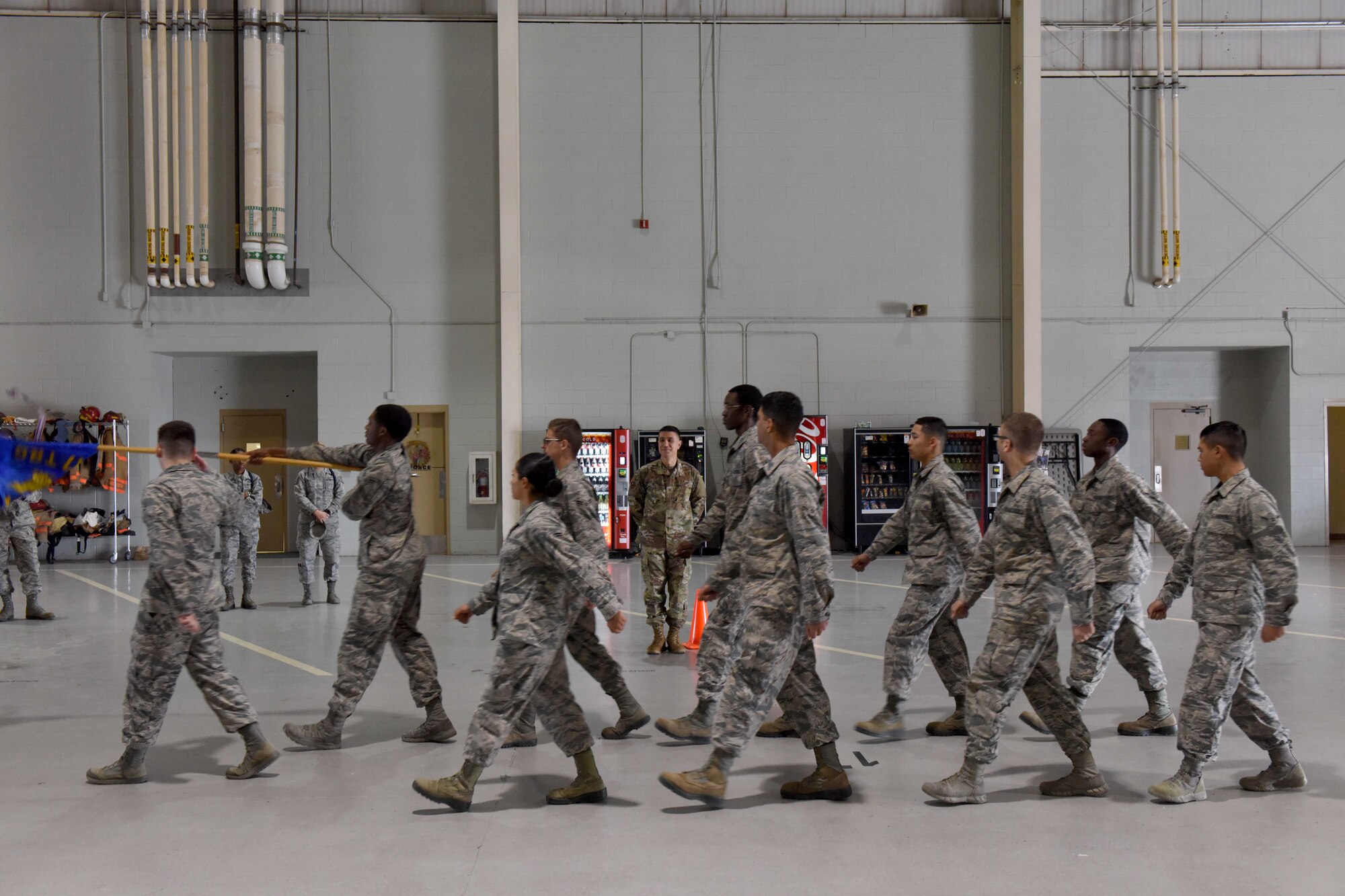 U.S. Air Force Col. Ricky Mills, 17th Training Wing commander, salutes Airmen from the 17th Training Group performing regulation drill during Retiree Appreciation Day at the Louis F. Garland Department of Defense Fire Academy on Goodfellow Air Force Base, Texas, Oct. 25, 2018. Regulation drill requires Airmen to march through a standard set of maneuvers. (U.S. Air Force photo by Senior Airman Randall Moose/Released)