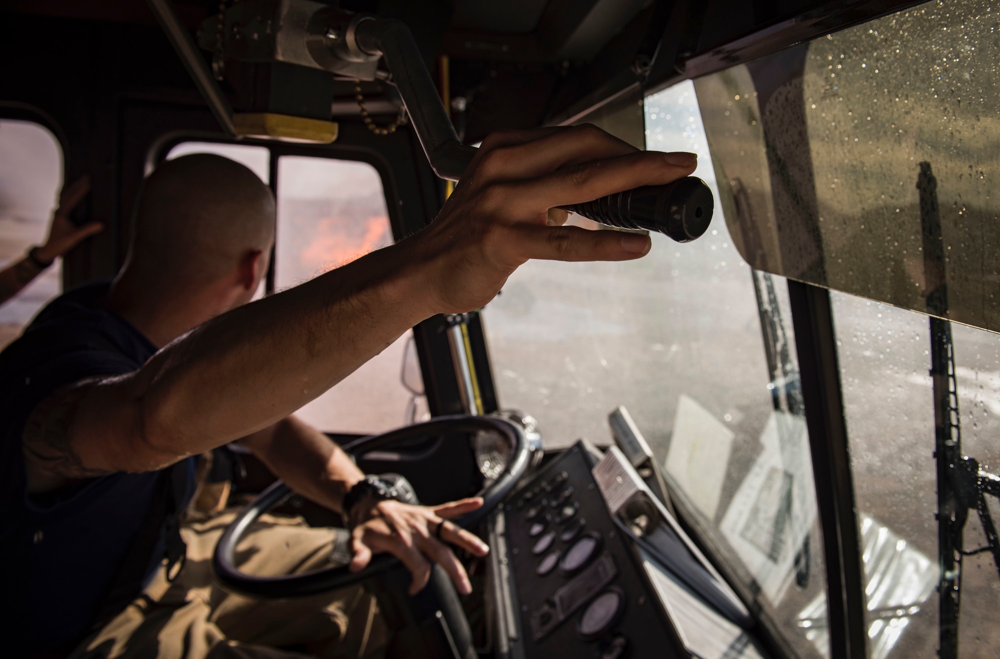 Airman 1st Class Matthew Trevizo, 99th Civil Engineer Squadron firefighter, maneuvers a water cannon on his fire truck towards a simulated aircraft fire during a training exercise Oct. 23, 2018, at Nellis Air Force Base, Nev. Trevizo was also responsible for driving the truck at the same time he operated the water cannon. (U.S. Air Force photo by Airman 1st Class Andrew D. Sarver)