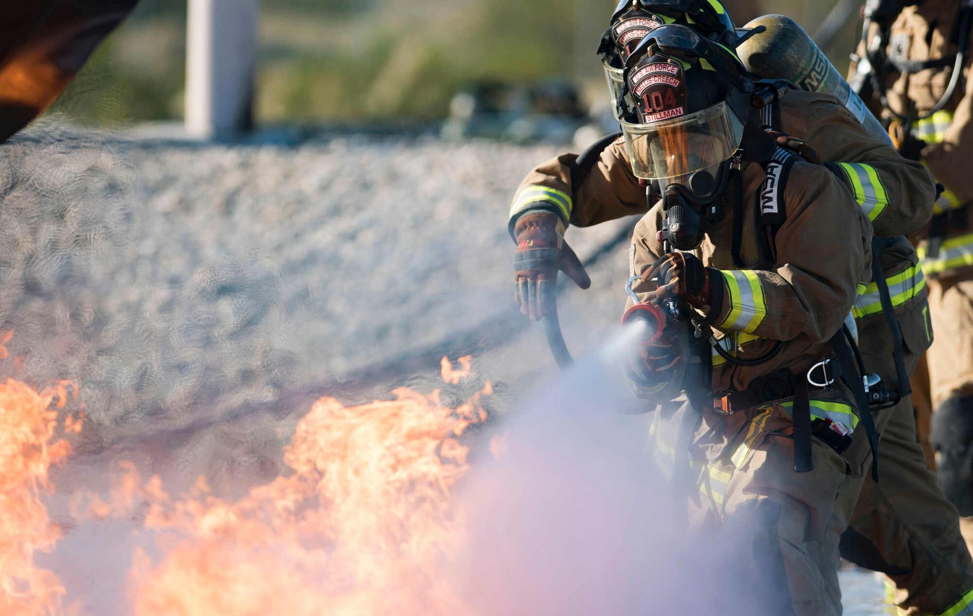 Airman 1st Class Christopher Stillman, 99th Civil Engineer Squadron firefighter, uses a hose to put out a fire during a training exercise Oct. 23, 2018, at Nellis Air Force Base, Nevada. The training exercise simulated a crashed plane and gave the firefighters an opportunity to practice fighting aircraft fires. (U.S. Air Force photo by Airman 1st Class Andrew D. Sarver)