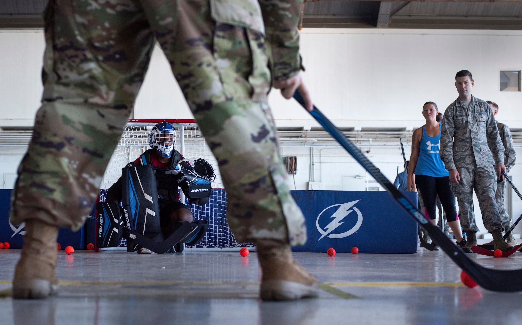 U.S. Air Force Airman 1st Class Ried Patton, an administrator assigned to the 6th Operation Support Squadron, defends a goal during street hockey practice at MacDill Air Force Base, Florida, Oct. 25, 2018.