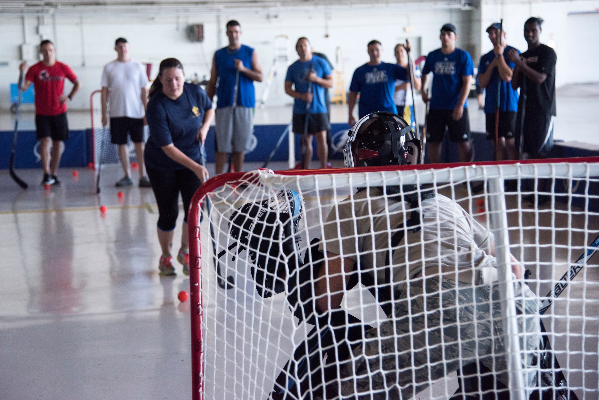 U.S. Air Force Airmen assigned to the 6th Air Mobility Wing and 927th Air Refueling Wing, play a street hockey shootout against the Tampa Bay Lightning’s Street Team at Hangar 4 on MacDill Air Force Base, Florida, Oct. 25, 2018.