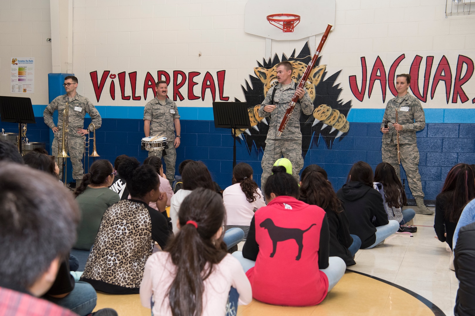 Airman 1st Class Burton Fowler, U.S. Air Force Band of the West bassoon player, with other members of the band introduces a bassoon to Villarreal Elementary students Oct 17, 2018 at San Antonio, Texas.