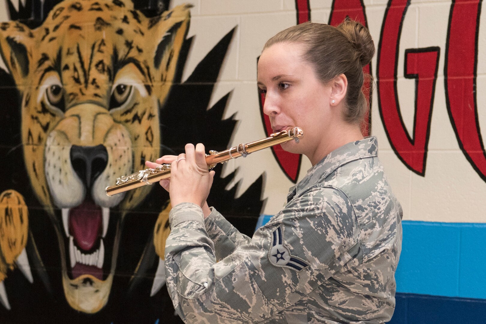 Airman 1st Class Elizabeth Robinson, U.S. Air Force Band of the West flutest, playings different styles of music on her instrument for Villarreal Elementary students Oct 17, 2018, at San Antonio, Texas.