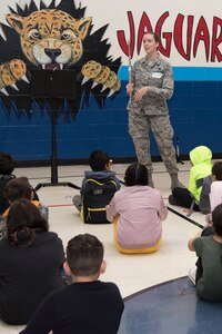 Airman 1st Class Elizabeth Robinson, U.S. Air Force Band of the West flutest, introduces her instrument to Villarreal Elementary students Oct 17, 2018, at San Antonio, Texas.