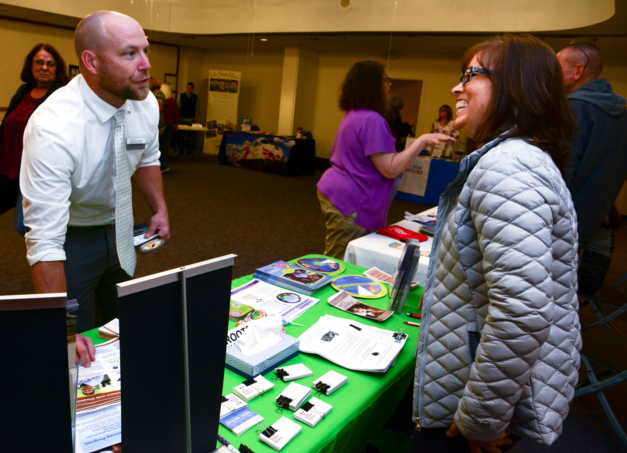 Kristopher Finfrock, New Mexico Workforce Connection Center veterans representative for Albuquerque, receives information about services provided by Life Roots from Jennifer Gutierrez at the Hero Wellness Information Fair Oct. 19, 2018 at Kirtland. The Fair is was put on in conjunction with National Disability Awareness Month.
There were multiple vendors and agencies on site to provide resources and information geared toward disabled, wounded warrior, and special needs families. (U.S. Air Force photo by Jessie Perkins)