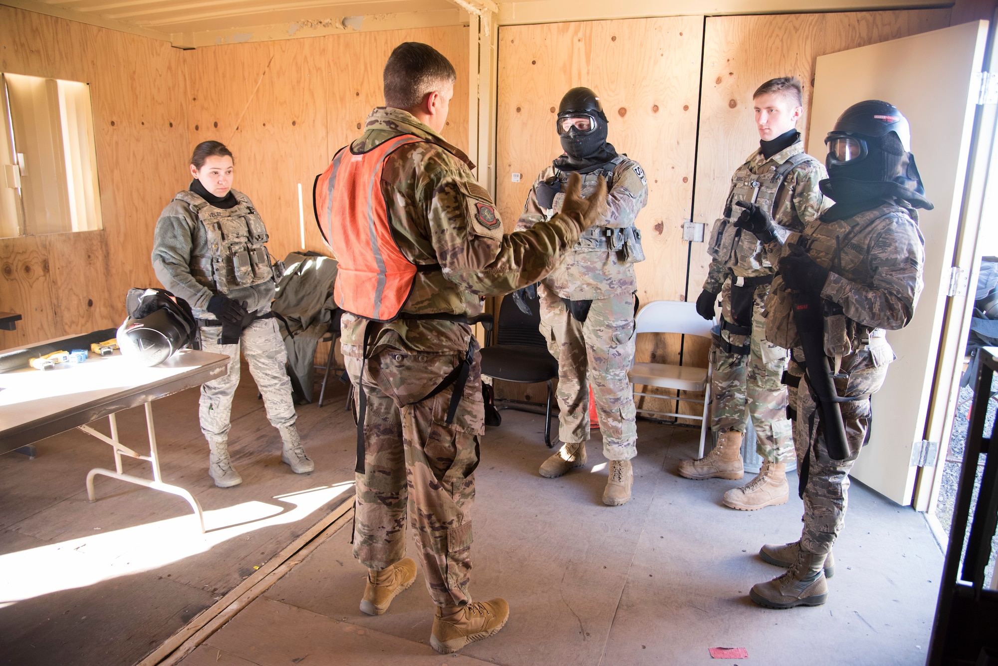 Airmen from the 92nd Security Forces Squadron are briefed on scenarios they may face during a high-risk situation training exercise at Fairchild Air Force Base, Washington, Oct. 15, 2018. SFS instructors provided immediate feedback to trainees on what went well and new approaches they may take to achieve a better outcome after each completed scenario. (U.S. Air Force photo/ Senior Airman Ryan Lackey)