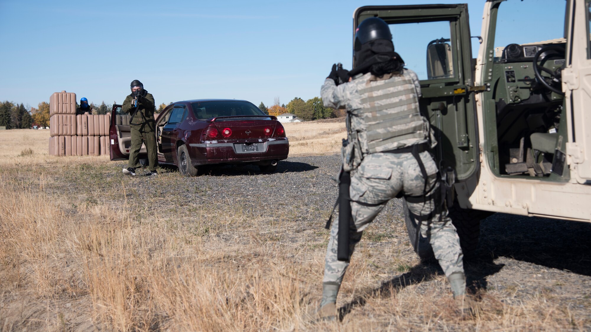 Airman 1st Class Tonya Brackens, 92nd Security Forces Squadron installation entry controller, simulates returning fire to an aggressive role-player during a high-risk situation training exercise at Fairchild Air Force Base, Washington, Oct. 15, 2018. Trainees practiced entry controller, traffic stops and domestic situations during which they didn’t know what they might encounter. Training how to approach an unknown situation is a vital skill Defenders have to learn to remain as safe as possible. (U.S. Air Force photo/ Senior Airman Ryan Lackey)