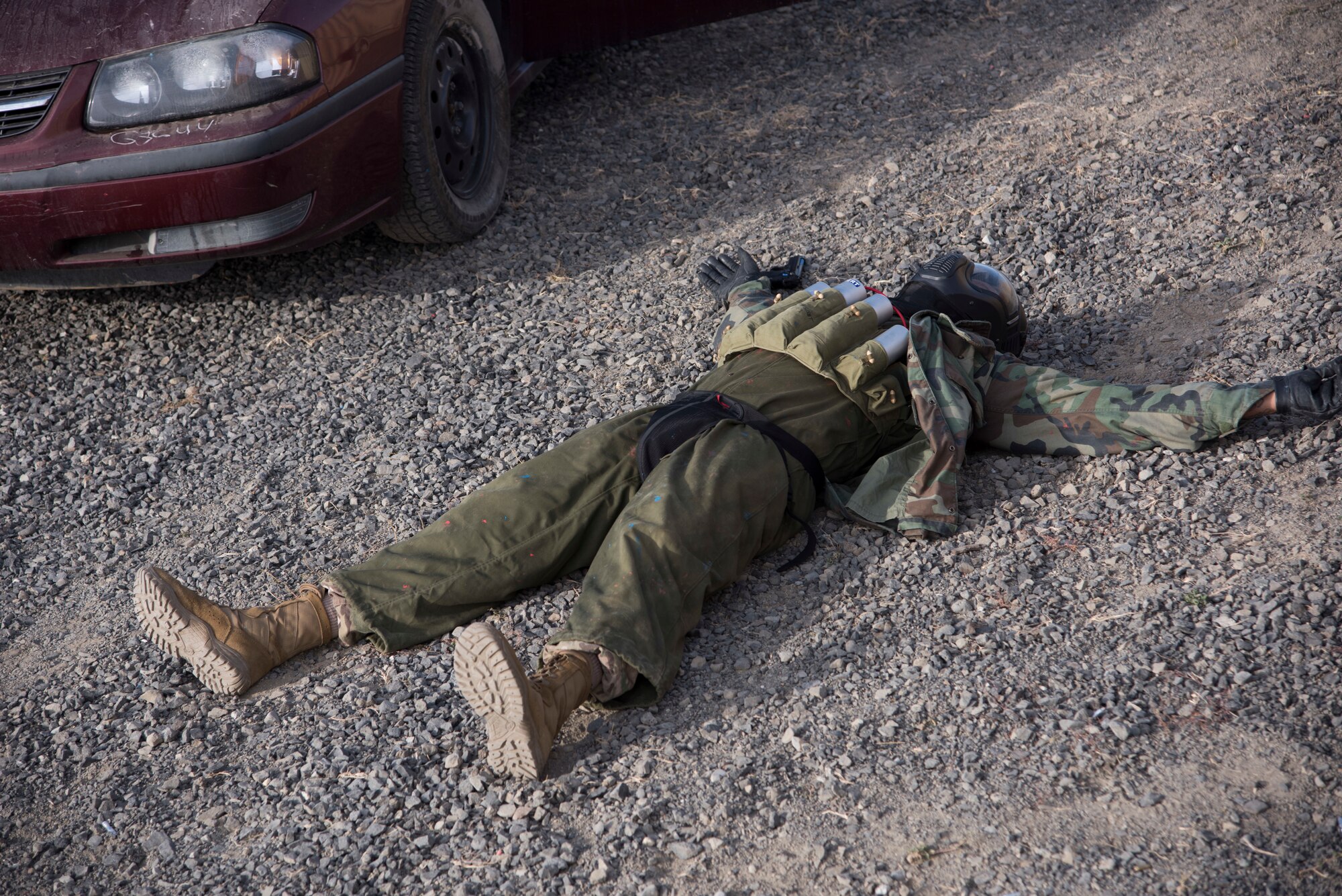 A role-player plays dead during a 92nd Security Forces Squadron high-risk situation training exercise at Fairchild Air Force Base, Washington, Oct. 15, 2018. Role-players changed tactics and responses to keep the training Defenders on their toes, forcing them to think on-the-fly to achieve the best possible outcome if routine encounters turn deadly. (U.S. Air Force photo/ Senior Airman Ryan Lackey)