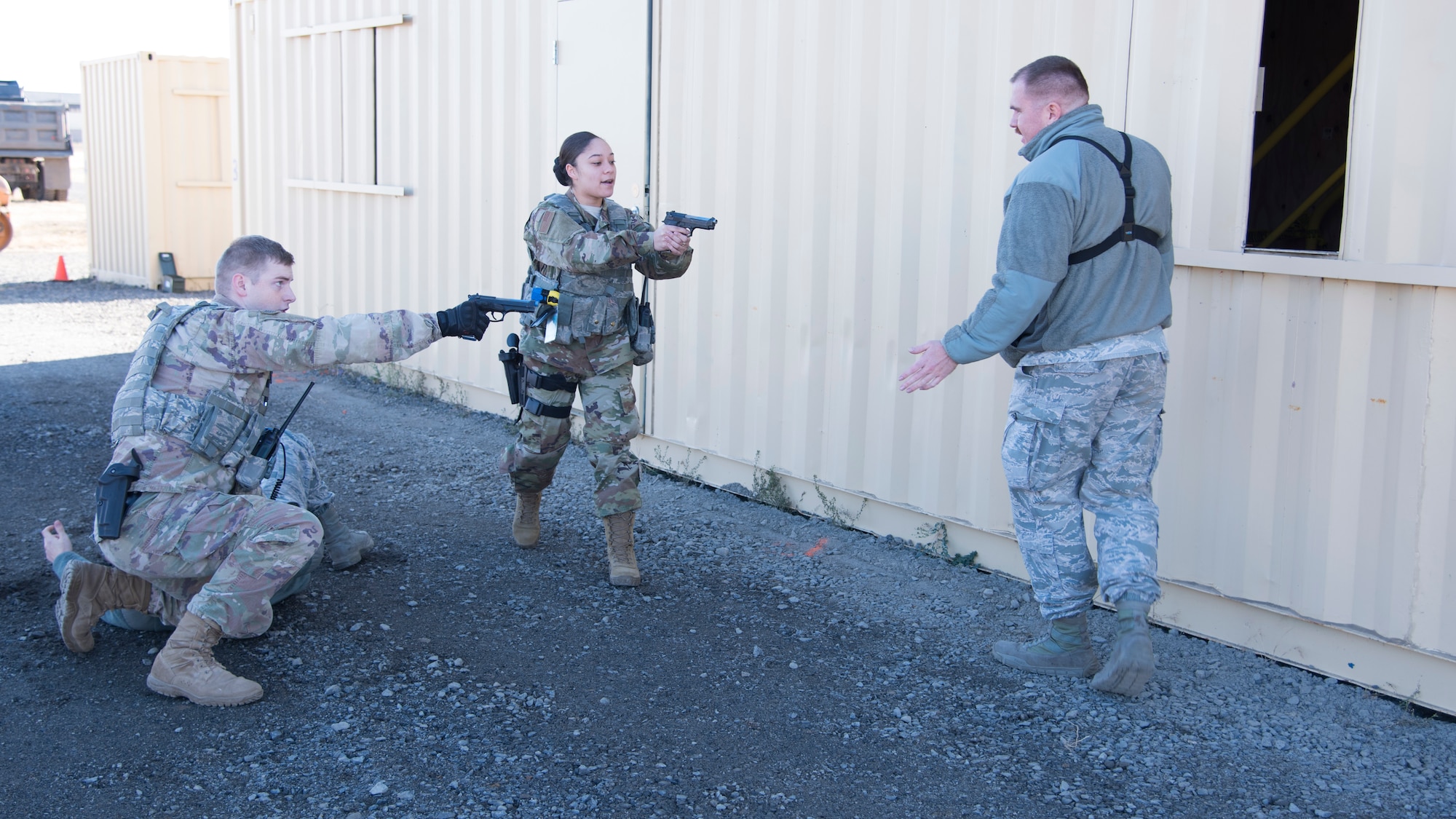 Airmen from the 92nd Security Forces Squadron simulate facing-off against an armed role-player during a high-risk situation training exercise at Fairchild Air Force Base, Washington, Oct. 15, 2018. The training scenarios mirrored past events Security Forces Airmen and civilian police forces alike have encountered at both deployed and domestic locations, so instructors already know what has worked in before to prepare their Airmen should it happen again. (U.S. Air Force photo/ Senior Airman Ryan Lackey)