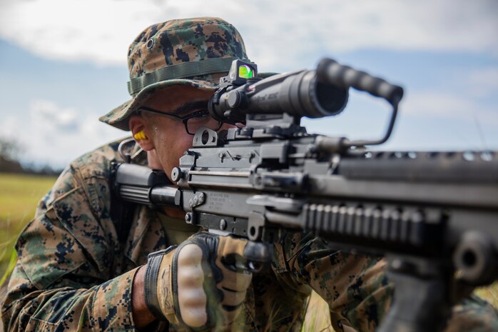 Lance Cpl. Markus Dodd sights in on a target with a M249 Light Machine Gun during a fire and movement range Oct. 24, 2018, at Camp Hansen, Okinawa, Japan. During the range, Marines with 3rd Marine Logistics Group practiced their marksmanship skills, improved their communication and worked on their weapons handling while engaging targets. Dodd is a native of Niles, Michigan, and is a machine gunner with the Tactical Readiness and Training, G-3, 3rd MLG Headquarters. (U.S. Marine Corps photo by Lance Cpl. Terry Wong)